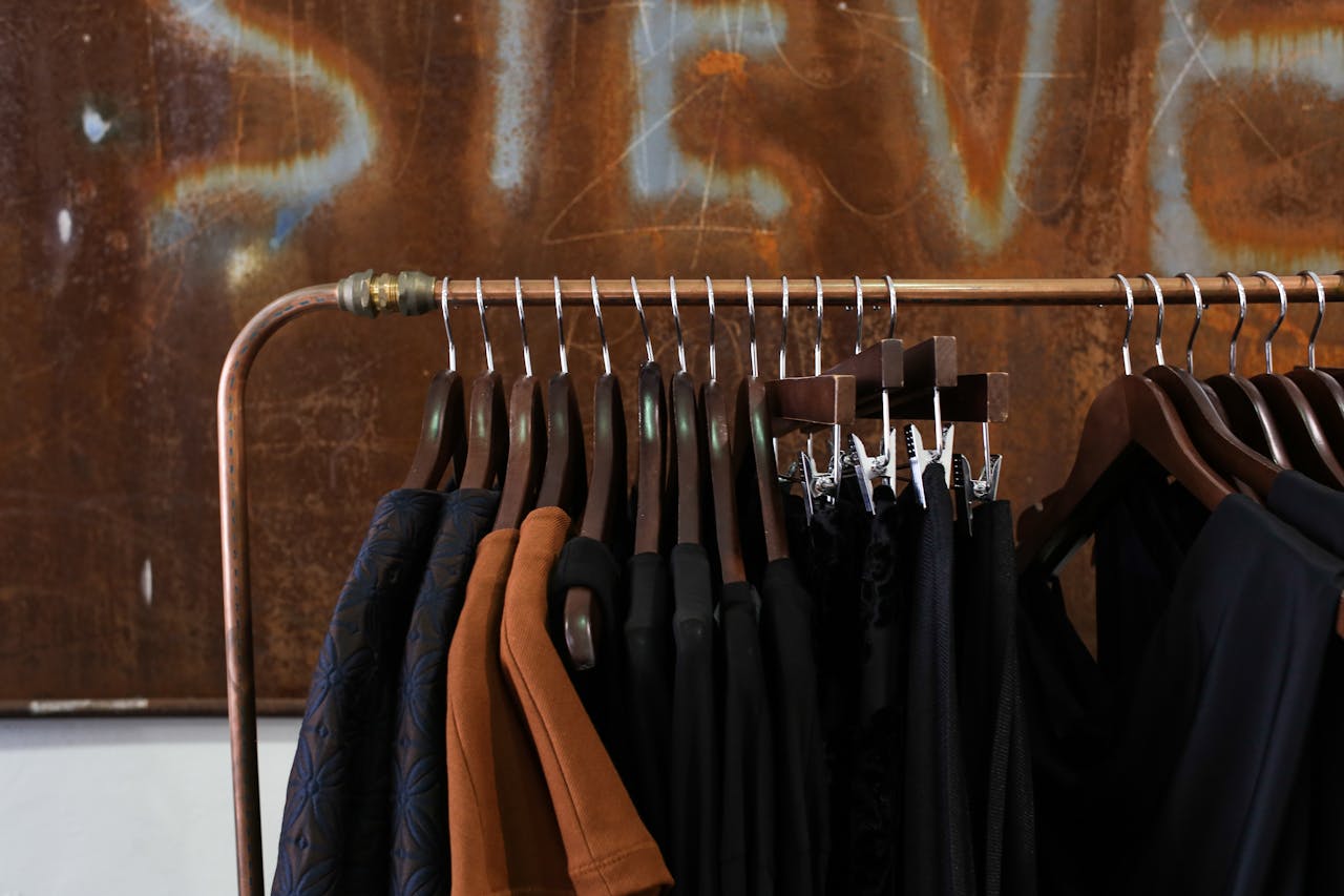 services-04 Modern clothing rack in a boutique with diverse garments and wooden hangers